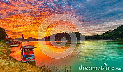 Touristic boat at sunset. Beautiful landscape. Luang Prabang. La Stock Photo