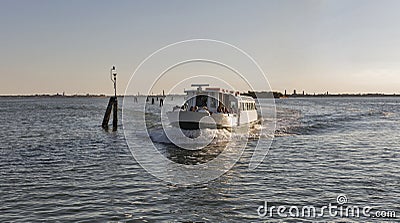 Touristic ship sails in Venice lagoon at sunset, Italy. Editorial Stock Photo