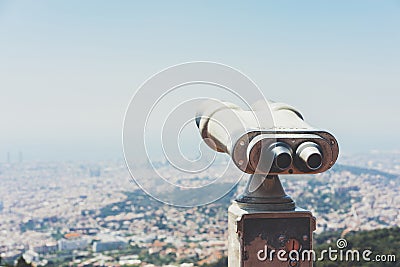 Touristic telescope look at the city with view of Barcelona Spain, close up old metal binoculars on background viewpoint overlook Stock Photo