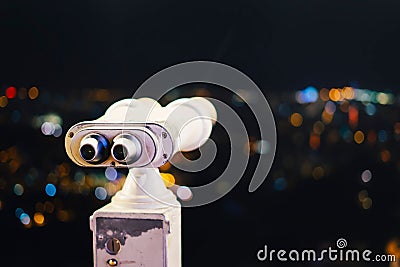 Touristic telescope look at city with view of Barcelona Spain, close up old metal binoculars on background viewpoint, hipster coin Stock Photo