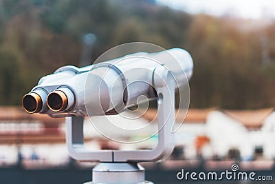 Touristic telescope look at the city with view snow mountains, closeup metal binocular on background viewpoint observe vision Stock Photo