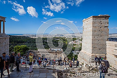 Tourists in the Acropolis Propylaea with Athens panorama background Editorial Stock Photo