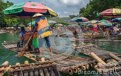 Tourists on bamboo rafts on Yulong River in Yangshuo Editorial Stock Photo