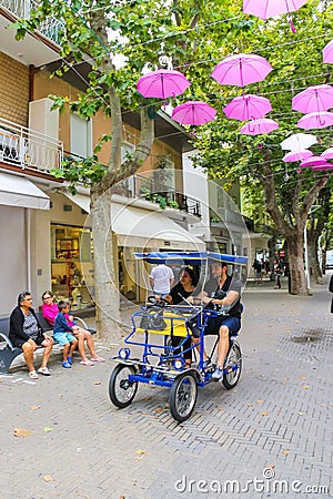 Tourists on a bicycle in Bellaria Igea Marina, Rimini Editorial Stock Photo