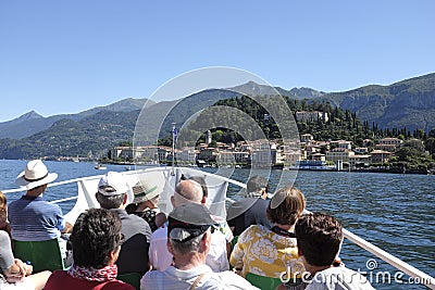 Tourists on board a boat approaching Bellagio,Lake Como. Editorial Stock Photo