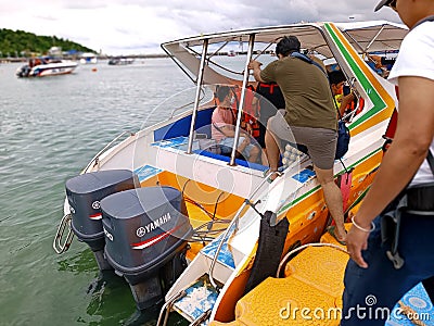 Tourists board a speedboat at the floating capital pier . Editorial Stock Photo