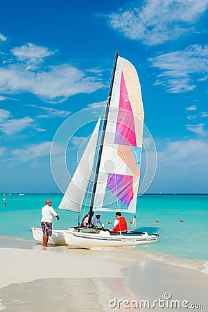 Tourists boarding a colorful boat at Varadero beach in Cuba Editorial Stock Photo