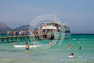 Tourists boarding off a cruise ship at Playa de Muro beach in Alcudia bay Editorial Stock Photo