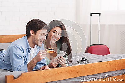 Tourists booking tickets, using phone and credit card Stock Photo