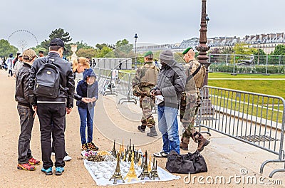Tourists buy souvenirs from street vendors in the garden of the Tuileries Editorial Stock Photo