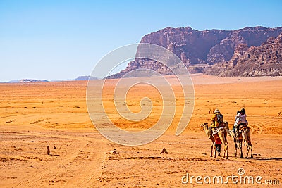 Tourists on camels crossing wadi rum desert in Jordan Editorial Stock Photo