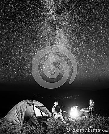 Tourists in camping at night against starry sky Stock Photo