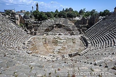 Tourists climb over the ruins of the Greco-Roman theatre at the ancient site of Myra at Demre in Turkey. Editorial Stock Photo