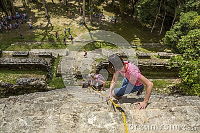 Tourists Climbing Down Mayan High Temple in Lamanai, Belize Editorial Stock Photo