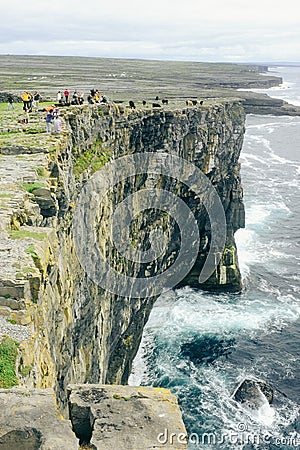 Tourists courageously look down a cliff Editorial Stock Photo