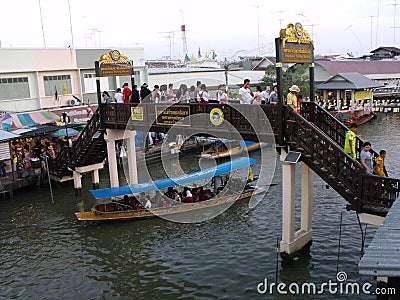 Tourists cross one of the bridges over the canal of the Amphawa Floating Market Editorial Stock Photo