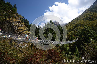 Tourists crossing a bridge in the Himalayas Editorial Stock Photo