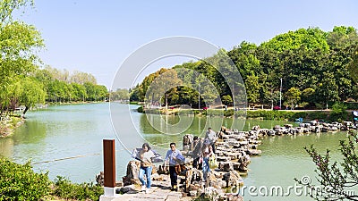 Tourists crossing overflow dams in Liuzhu Gorge Editorial Stock Photo