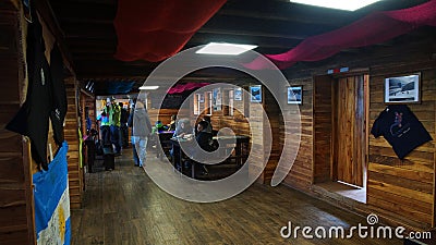 Tourists eating inside the Jose Rivas refuge located at 4800 meters in the volcano Cotopaxi Editorial Stock Photo