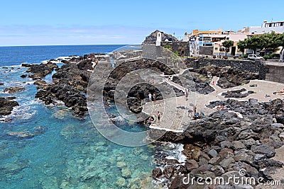 Tourists at the El Caleton natural pools next to the San Miguel castle in Garachico, Tenerife. Spain Editorial Stock Photo