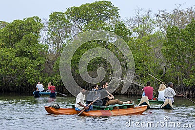 Tourists enjoy a late afternoon paddle boat ride on the Pottuvil Lagoon on the east coast of Sri Lanka. Editorial Stock Photo