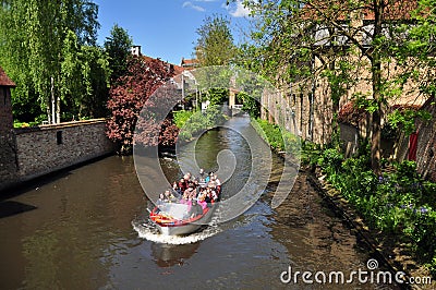 Tourists enjoy panoramic boat cruise along the canal, Bruges Editorial Stock Photo