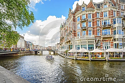 Tourists enjoy a relaxing waterfront lunch at a hotel on one of the major canals near the Museum District in Amsterdam Netherlands Editorial Stock Photo