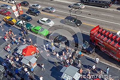 tourists enjoy walking at the walk of fame, the hollywood boulevard, looking for the foot and handprints and of the stars at the Editorial Stock Photo