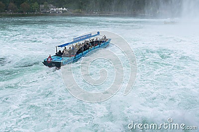 Tourists enjoying boat trip in Rheinfall waterfall in Switzerland Editorial Stock Photo