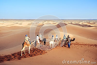 Tourists enjoying with camel caravan in the Sahara desert. Merzouga, Morocco. Editorial Stock Photo