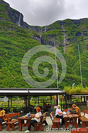 Kjelfossen waterfalls tourists outdoor seatings Gudvangen Norway Editorial Stock Photo