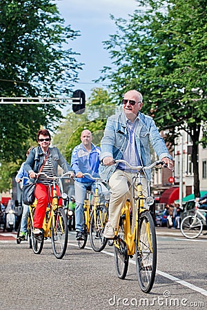 Tourists explore city on rental bike, Amsterdam, Netherlands Editorial Stock Photo