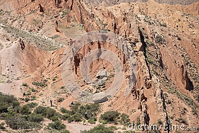 Tourists explore the dramatic landscape of the Fairy Tale Canyon, or Skazka Canyon in Kyrgyzstan Stock Photo