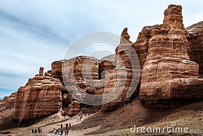 Tourists explore the Red rocks in the Charyn canyon Editorial Stock Photo