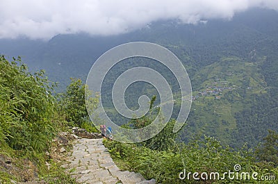 Tourists follow the trail among the mountains of Nepal Himalayas Editorial Stock Photo