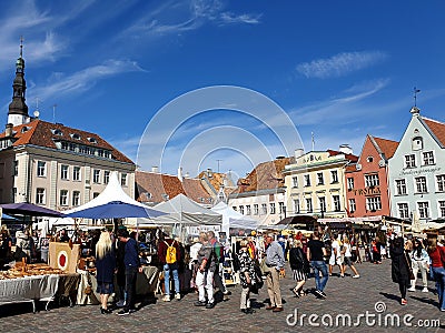 Tourists gathered in Raekoja Plats old marketplace in medieval town of Tallinn, Estonia. People of different nationalities. Editorial Stock Photo