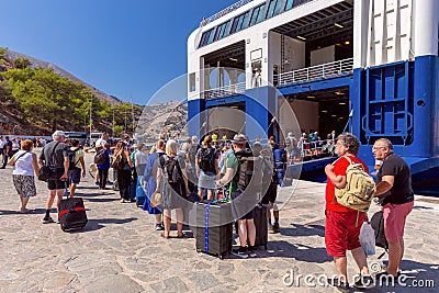 Tourists go to the Blue Star sea ferry on Symi Island Editorial Stock Photo