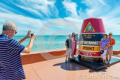 Tourists posing at Continental USA`s Southernmost Point in Key West Florida Editorial Stock Photo