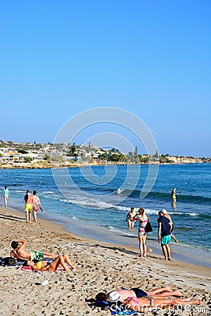 Tourists on Hersonissos beach, Crete. Editorial Stock Photo