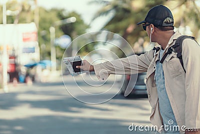 Tourists hold maps and hitchhiking. backpacker and travel concept Stock Photo