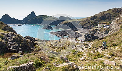 Tourists and holidaymakers walking down to the beach to enjoy late summer sunshine at Kynance Cove beach The Lizard Cornwall Editorial Stock Photo