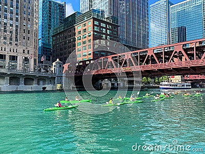 Tourists in kayaks and on tour boats pass each other on the Chicago River Editorial Stock Photo