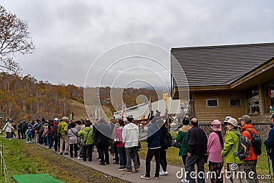 Tourists line up for the Dragondola in Summit Station (Naeba-Tashiro Gondola), in autumn foliage season Editorial Stock Photo