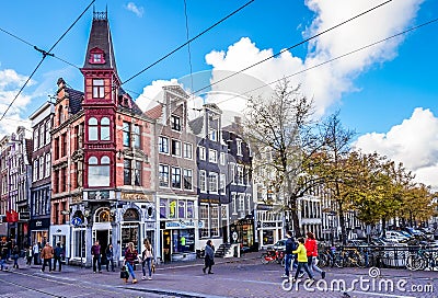 Tourists and locals on the busy intersection of the Keizerstraat and Leidsestraat in the center of the old city of Amsterdam Editorial Stock Photo