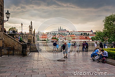 Tourists looking at the Charles Bridge and Prague Castle in Prague during Sunset, Czech Republic. Editorial Stock Photo