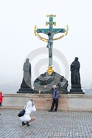 Tourists make photo on Charles Bridge in Prague Editorial Stock Photo