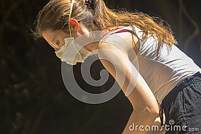 Tourists in medical masks to protect their nasopharynx but not skin. Risk of holidays in Southeast Asia. Close-up of girl from Editorial Stock Photo