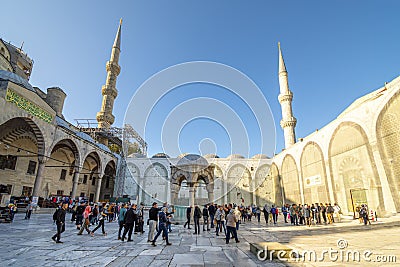 Tourists, Muslim worshipers, and visitors visit the interior square inside the Blue Mosque in the Sultanahmet district of Istanbul Editorial Stock Photo