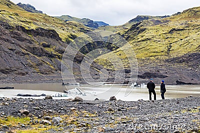 Tourists near pool of Solheimajokull glacier Editorial Stock Photo