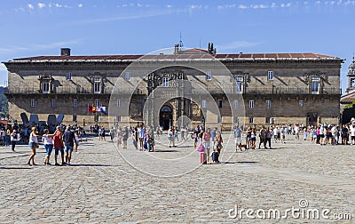 Tourists at the Obradoiro Square in front of the Hostal de Los Reyes Católicos. Santiago de Compostela, Galicia, Spain. Editorial Stock Photo